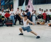 Sifu Jason Wong performing a CLF form in the welcoming lion dancing ceremony, Grandmaster Wong drumming for him
